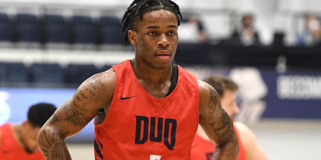 Jackie Johnson III #5 of the Duquesne Dukes looks on during a college basketball game against the George Washington Colonials at the Smith Center on March 2, 2022 in Washington, DC.
