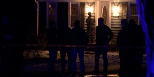 Police stand outside the home at 47 Summer Street in Duxbury, Massachusetts, investigating after two children were found dead. 