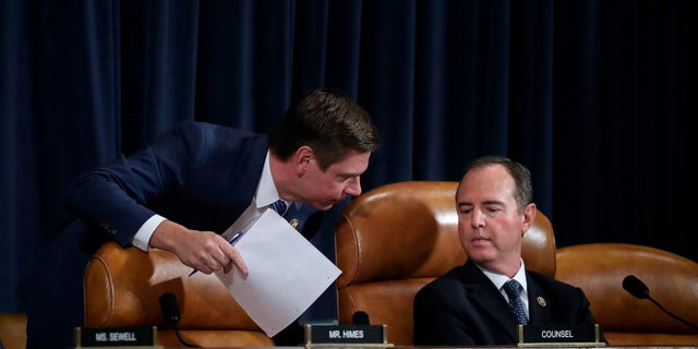 WASHINGTON, DC - NOVEMBER 19: (L-R) Rep. Eric Swalwell (D-CA) confers with committee chairman Rep. Adam Schiff (D-CA) as they listen to former National Security Council Senior Director for European and Russian Affairs Tim Morrison testify before the House Intelligence Committee in Washington, DC. 