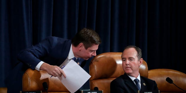 WASHINGTON, DC - NOVEMBER 19: (L-R) Rep. Eric Swalwell (D-CA) confers with committee chairman Rep. Adam Schiff (D-CA) as they listen to former National Security Council Senior Director for European and Russian Affairs Tim Morrison testify before the House Intelligence Committee in Washington, DC.