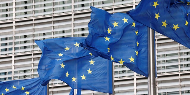 European Union flags are seen outside the EU Commission headquarters in Brussels, Belgium, on Sept. 28, 2022. 