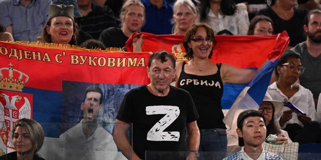 A man wearing a "Z" T-shirt watches the match between Novak Djokovic and Andrey Ruble at the Australian Open in Melbourne on Jan. 25, 2023.