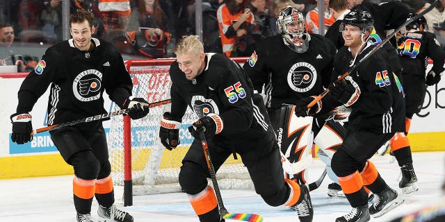 Joel Farabee #86, Rasmus Ristolainen #55, Carter Hart #79, and Cam York #45 of the Philadelphia Flyers skate during warm-ups prior to their game against the Anaheim Ducks at the Wells Fargo Center on January 17, 2023 in Philadelphia, Pennsylvania. The Flyers are wearing limited edition jerseys during warmups to celebrate Pride Night tonight.