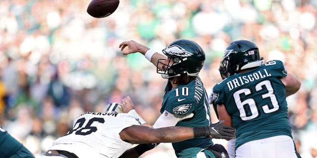 Gardner Minshew #10 of the Philadelphia Eagles passes under pressure from Carl Granderson #96 of the New Orleans Saints during the second half at Lincoln Financial Field on January 01, 2023 in Philadelphia, Pennsylvania.