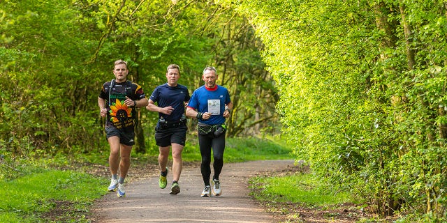 Through rain or shine, McKee (above, far right) was determined to run 26.2 miles every day during the year of 2022.