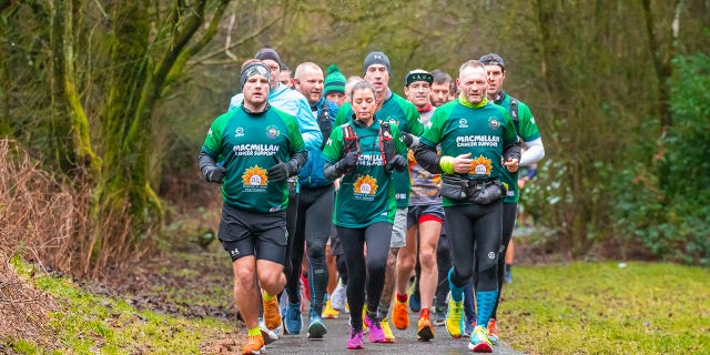 McKee (far right, front) raised about $1.2 million for Macmillan Cancer Support and Hospice at Home West Cumbria.