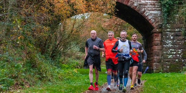 In his marathon running, McKee was joined by members of his community, who ran alongside him.