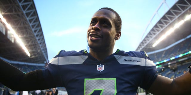 The Seattle Seahawks' #7 Geno Smith celebrates with fans after defeating the New York Jets at Lumen Field on January 01, 2023, in Seattle, Washington.