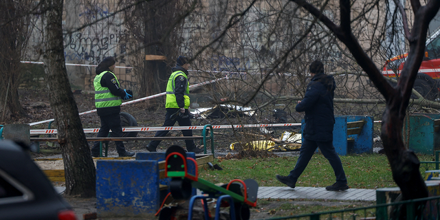 Police and emergency personnel work at the site of a helicopter crash in the town of Brovary, outside Kyiv.