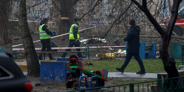 Police and emergency personnel work at the site of a helicopter crash in the town of Brovary, outside Kyiv.