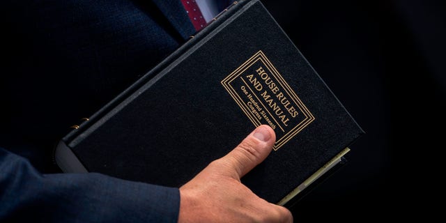 Rep. Mike Johnson, R-La., holds a House Rules and Manual book during a news conference outside the U.S. Capitol in Washington, D.C., on May 27, 2020.