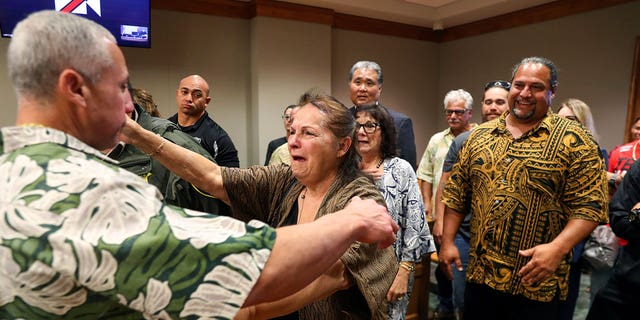 Ian Schweitzer, left, hugs his mother, Linda, moments after he was released from prison, in Hilo, Hawaii, on Jan. 24, 2023.
