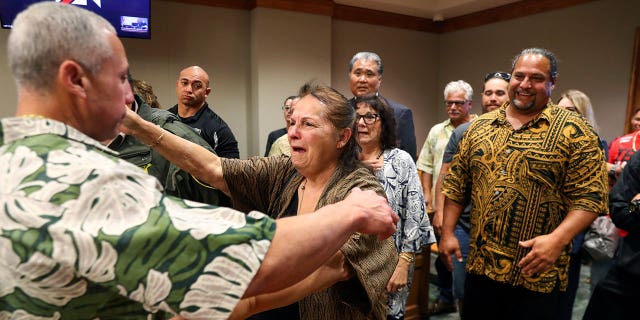 Ian Schweitzer, left, hugs his mother, Linda, moments after he was released from prison, in Hilo, Hawaii, on Jan. 24, 2023.