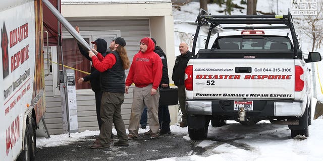 A cleanup crew works at the King Road crime scene on Dec. 30, 2022.