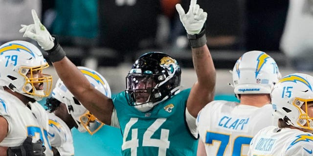 Jacksonville Jaguars linebacker Travon Walker (44) celebrates as Los Angeles Chargers place kicker Cameron Dicker (15) misses a field goal during the second of an NFL wild-card football game, Saturday, Jan. 14, 2023, in Jacksonville, Fla.