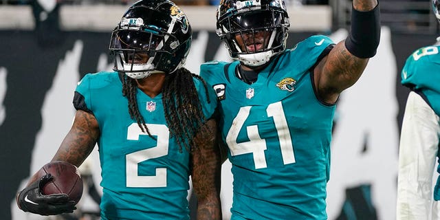 Jacksonville Jaguars linebacker Josh Allen (41) and safety Rayshawn Jenkins (2) celebrate their hit that forced a fumble and their return for a touchdown in the second half of an NFL football game against the Tennessee Titans, Saturday, Jan. 7, 2023, in Jacksonville, Fla.