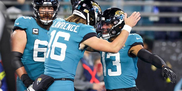 Trevor Lawrence #16 of the Jacksonville Jaguars celebrates with Christian Kirk #13 of the Jacksonville Jaguars after Kirk's receiving touchdown during the second quarter against the Tennessee Titans at TIAA Bank Field on January 7, 2023 in Jacksonville, Florida. 