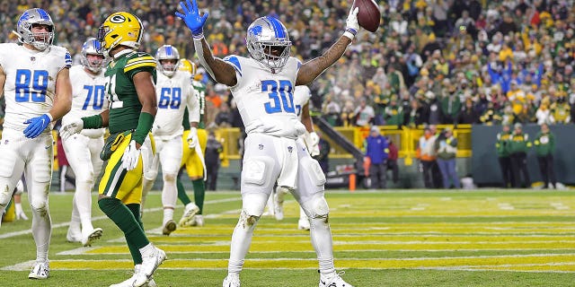 Jamaal Williams #30 of the Detroit Lions celebrates a touchdown during a game against the Green Bay Packers at Lambeau Field on January 08, 2023 in Green Bay, Wisconsin. The Lions defeated the Packers 20-16.
