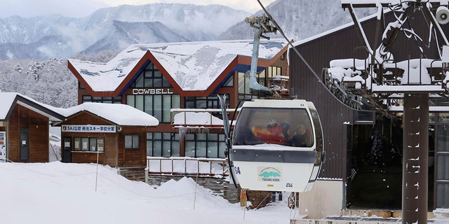 Police officers, on gondola, head to the site of an avalanche, at a ski resort in the village of Otari, Nagano prefecture, Japan on Sunday.