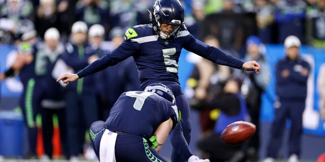 Jason Myers #5 of the Seattle Seahawks kicks the winning field goal against the Los Angeles Rams during overtime to win the game at Lumen Field on January 08, 2023 in Seattle, Washington.