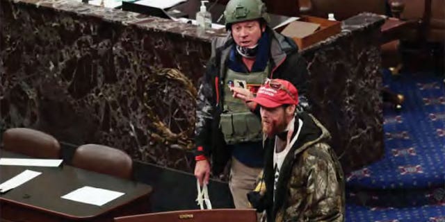 Joshua Black werd op 6 januari 2021 op de Senaatsvloer gezien met een rode hoed, gecamoufleerd jack en gele handschoenen. Er is bloed op zijn gezicht te zien nadat hij werd neergeschoten door een politieprojectiel in het Capitool.