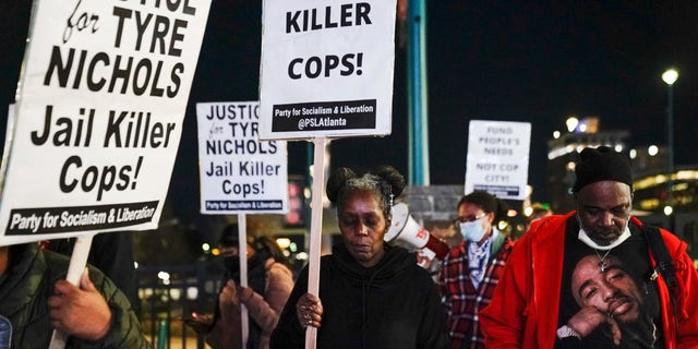 Protesters in Atlanta, Georgia, observe a moment of silence during rally against the fatal police assault of Tyre Nichols on Jan. 27, 2023.
