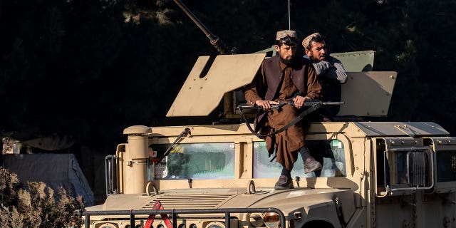 Taliban fighters stand guard at the site of an explosion, near the Interior Ministry, in Kabul, Afghanistan, Sunday, Jan. 1, 2023. A bomb exploded near a checkpoint at Kabul's military airport Sunday morning killing and wounding several people, a Taliban official said, the first deadly blast of 2023 in Afghanistan. 