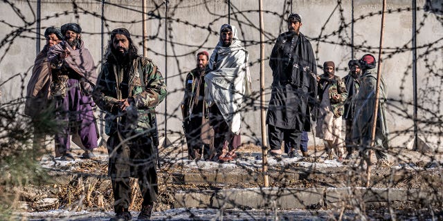 Taliban fighters check the site of an explosion, near the Interior Ministry, in Kabul, Afghanistan, Sunday, Jan. 1, 2023. A bomb exploded near a checkpoint at Kabul's military airport Sunday morning killing and wounding several people, a Taliban official said, the first deadly blast of 2023 in Afghanistan. 