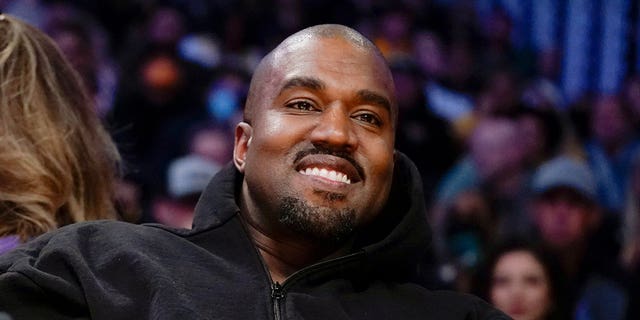 Kanye West, known as Ye, watches the first half of an NBA basketball game in Los Angeles, on March 11, 2022. 