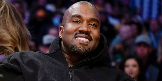 Kanye West, known as Ye, watches the first half of an NBA basketball game in Los Angeles, on March 11, 2022. 