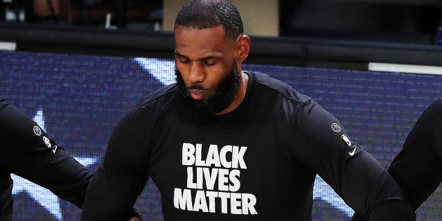 LeBron James of the Los Angeles Lakers kneels during the national anthem before the start of a game against the Houston Rockets in Game 5 of the Western Conference second round during the 2020 NBA Playoffs on September 12, 2020 in Lake Buena View, Florida.