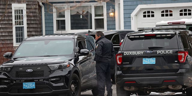 Duxbury police work at the scene where two children were found dead and an infant was found injured, Jan. 25, 2023, in Duxbury, Massachusetts.