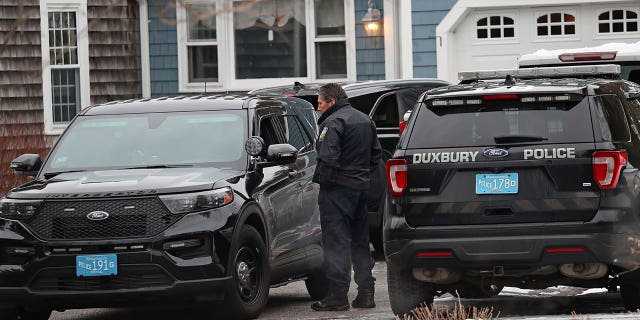 Duxbury Police work at the scene where two children were found dead, and an infant injured, Wednesday, Jan. 25, 2023, in Duxbury, Mass.