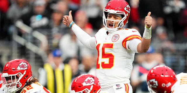 Patrick Mahomes (15) of the Kansas City Chiefs signals at the line of scrimmage against the Las Vegas Raiders during the first half of a game at Allegiant Stadium Jan. 7, 2023, in Las Vegas.
