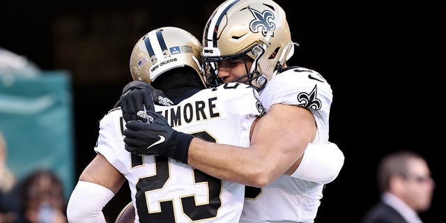 Marshon Lattimore #23 of the New Orleans Saints is congratulated by Kaden Elliss #55 of the New Orleans Saints after an interception returned for a touchdown against the Philadelphia Eagles during the fourth quarter at Lincoln Financial Field on January 01, 2023 in Philadelphia, Pennsylvania.