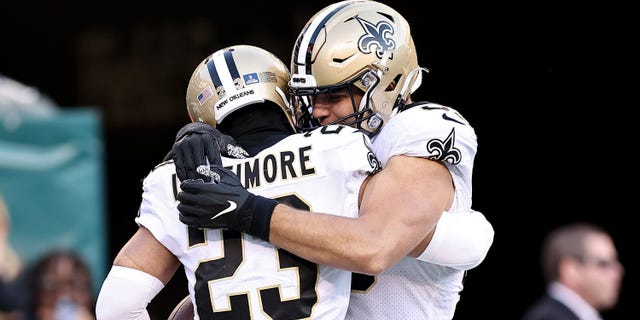 Marshon Lattimore #23 of the New Orleans Saints is congratulated by Kaden Elliss #55 of the New Orleans Saints after an interception returned for a touchdown against the Philadelphia Eagles during the fourth quarter at Lincoln Financial Field on January 01, 2023 in Philadelphia, Pennsylvania.