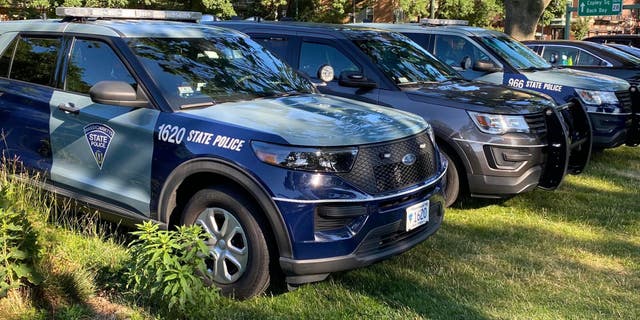 Massachusetts State Police vehicles parked outside a building.