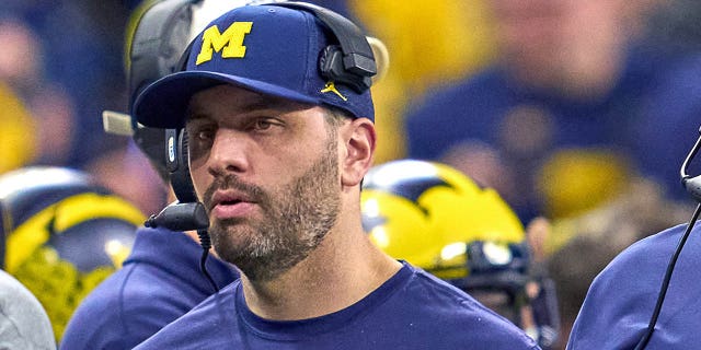 Michigan Wolverines Co-Offensive Coordinator Matt Weiss looks on during the Big Ten Championship Game between the Iowa Hawkeyes and the Michigan Wolverines on December 04, 2021, at Lucas Oil Stadium, in Indianapolis.