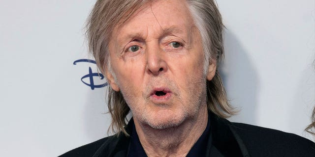 Paul McCartney poses for photographers at the premiere of the film "If These Walls Could Sing" in London, on Dec. 12, 2022. 
