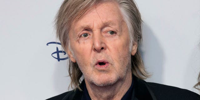 Paul McCartney poses for photographers at the premiere of the film "If These Walls Could Sing" in London, on Dec. 12, 2022.