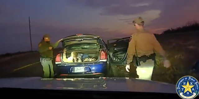 In the trunk of the car, law enforcement officers found two illegal immigrants.