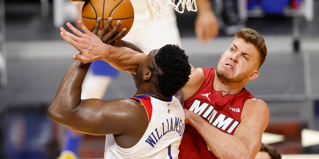 Meyers Leonard, #0 of the Miami Heat, fouls against Zion Williamson, #1 of the New Orleans Pelicans, during the second quarter at American Airlines Arena on December 25, 2020 in Miami.