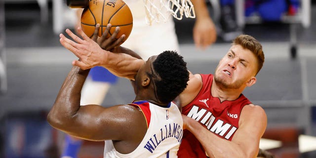 Meyers Leonard, #0 of the Miami Heat, fouls against Zion Williamson, #1 of the New Orleans Pelicans, during the second quarter at American Airlines Arena on December 25, 2020 in Miami.