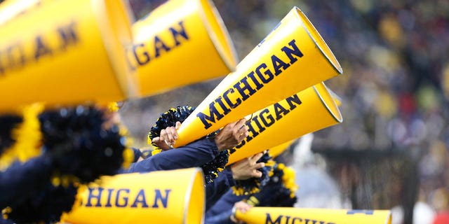 A general view of Michigan cheerleaders yelling into their megaphones on November 12, 2022 at Michigan Stadium in Ann Arbor, Michigan. 