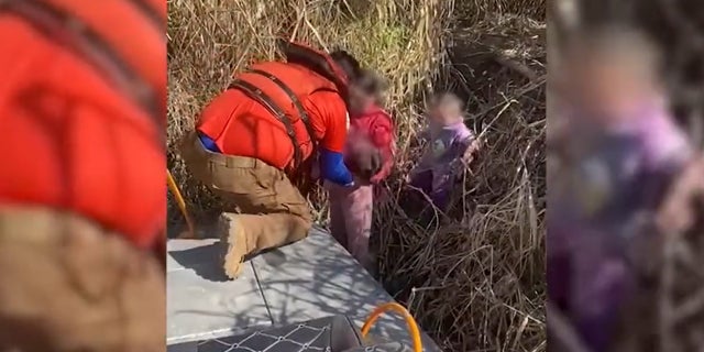 Still image from a video released by the Mexican National Institute of Migration showing the rescue of three sisters abandoned at the border.