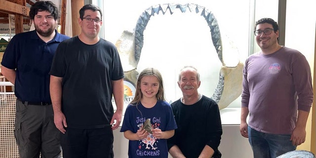 Molly Sampson (center) visited Dr. Stephen J. Godfrey (sitting beside her), curator of paleontology at Calvert Marine Museum, who helped share intriguing information about the megalodon tooth she found.