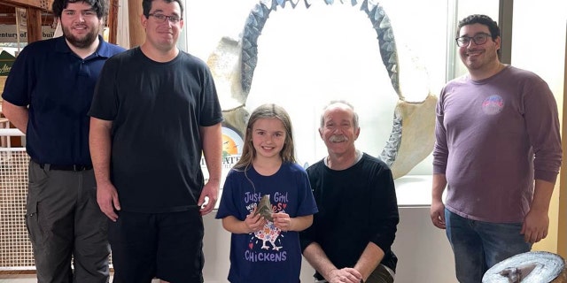 Molly Sampson (center) visited Dr. Stephen J. Godfrey (sitting beside her), curator of paleontology at Calvert Marine Museum, who helped share intriguing information about the megalodon tooth she found.