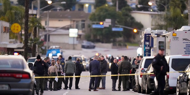 Law enforcement personnel gather outside a ballroom dance club in Monterey Park, Calif., Sunday, Jan. 22, 2023. A mass shooting took place at the dance club following a Lunar New Year celebration, setting off a manhunt for the suspect.