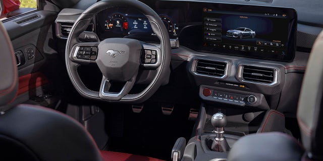 The 2024 Mustang features a digital instrument cluster and central touchscreen display.