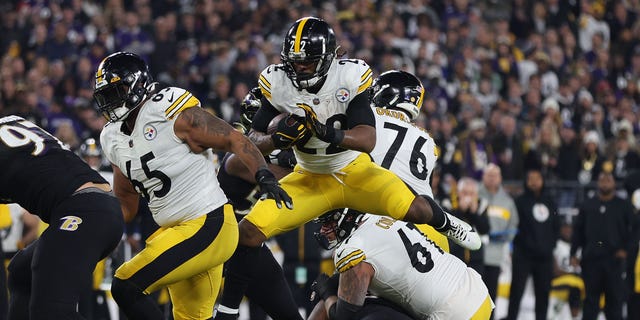 Najee Harris #22 of the Pittsburgh Steelers leaps over a defender against the Baltimore Ravens during the first quarter at M&amp;amp;T Bank Stadium on January 01, 2023 in Baltimore, Maryland.